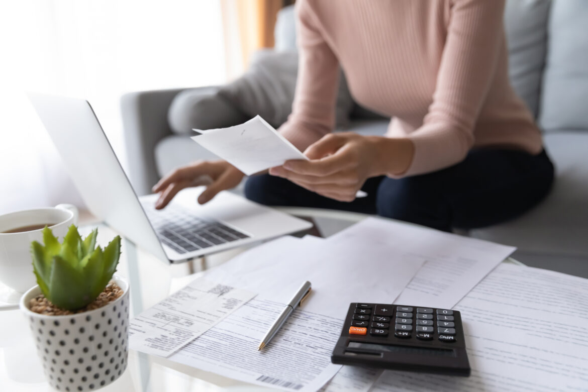 Woman sitting at laptop filing tax return